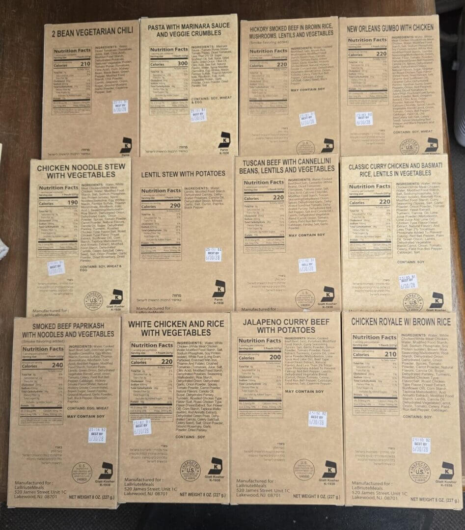 A collection of vintage comic book backs arranged in a grid on a wooden floor.